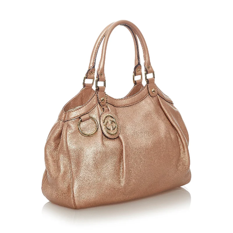 Ladies Gucci shoulder bags with a tassel decorationBeige Gucci Sukey Leather Tote Bag