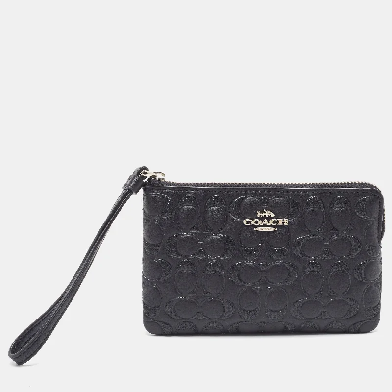 Ladies Coach Tabby bags with a textured leather surface for a more tactile lookBlack Signature Glitter Embossed Leather Boxed Wristlet Clutch