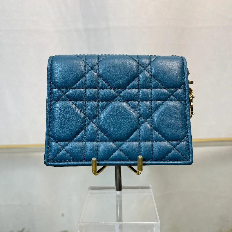 Christian Dior Saddle bags with a studded trim for a bold lookDior Mini Lady Dior Gardenia Deep Ocean Wallet